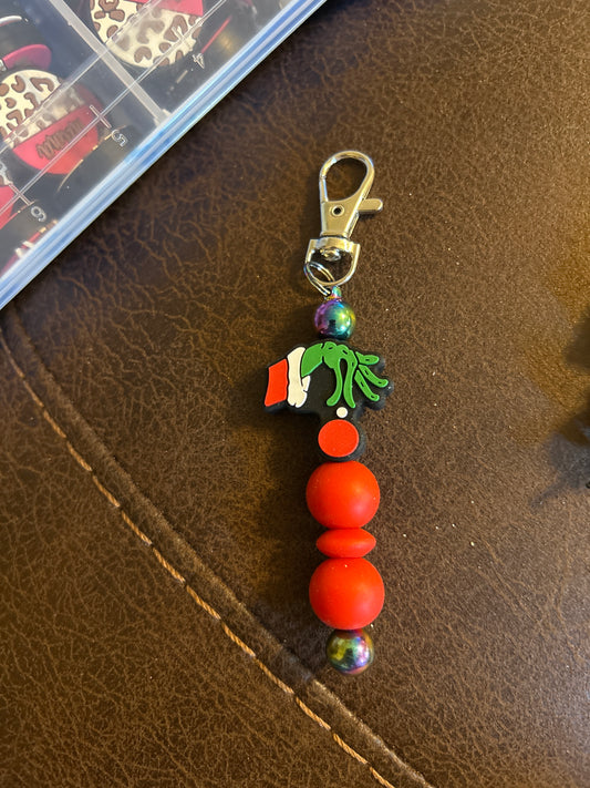 Grinch Hand Holding An Ornament