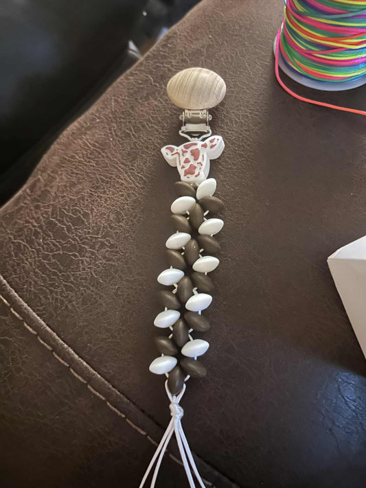 Brown and white cow head pacifier clip